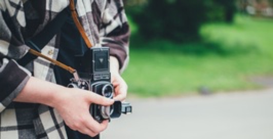 Picture of a person holding a film camera